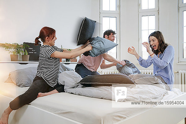 Carefree family having a pillow fight