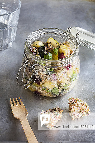 Jar of gluten free vegan salad with buckwheat  zucchini and paprika