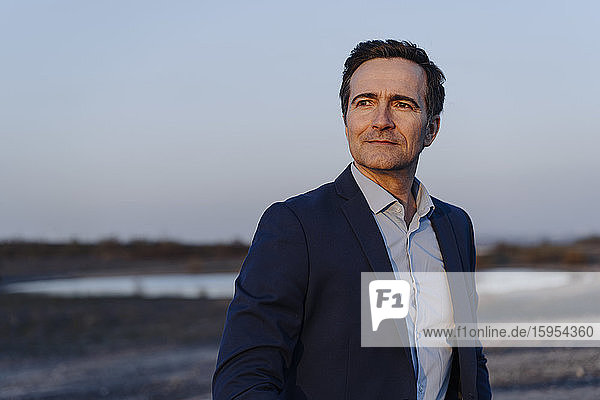 Portrait of a confident mature businessman on a disused mine tip