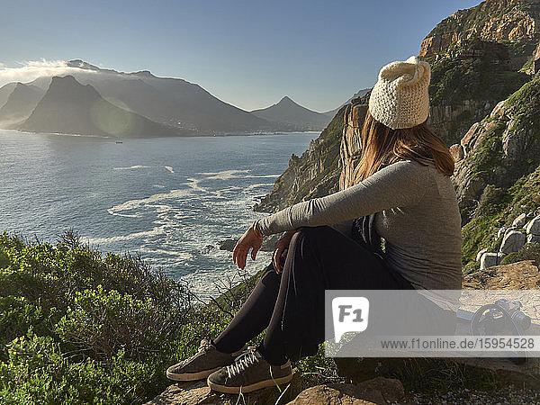 Woman enjoying the view from the top of a mountain  Chapman's Peak Drive  South Africa