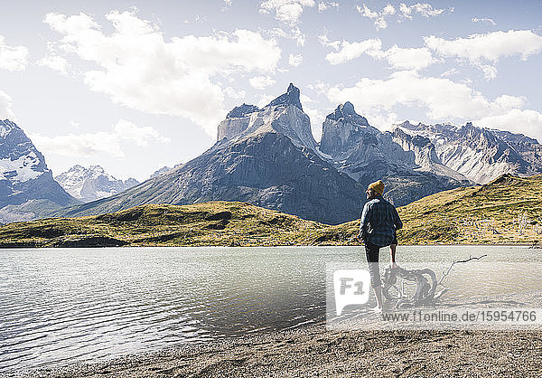 Hiker in mountainscape at lakeside in Torres del Paine National Park  Patagonia  Chile