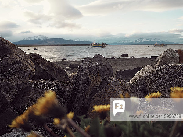 Surface level view of rocks against boat on the sea  Puerto Natales  Chile