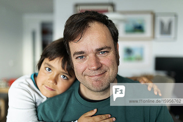 Portrait of father at home with his son