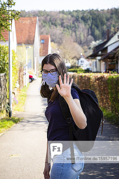 Teenage girl on her way to school  wearing face mask