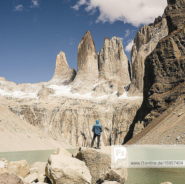 Hiker in mountainscape at lakeside at Mirador Las Torres in Torres del Paine National Park  Patagonia  Chile