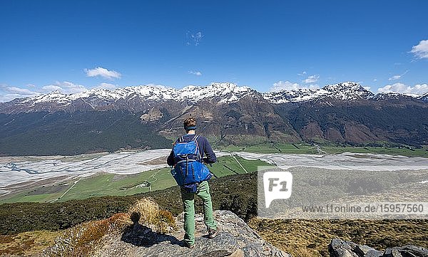 Hiker on the summit of Mount Alfred  view of Dart RIver and mountain range  Glenorchy near Queenstown  Southern Alps  Otago  South Island  New Zealand  Oceania