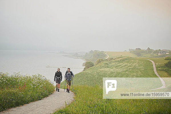 Two people walking along a coastal path