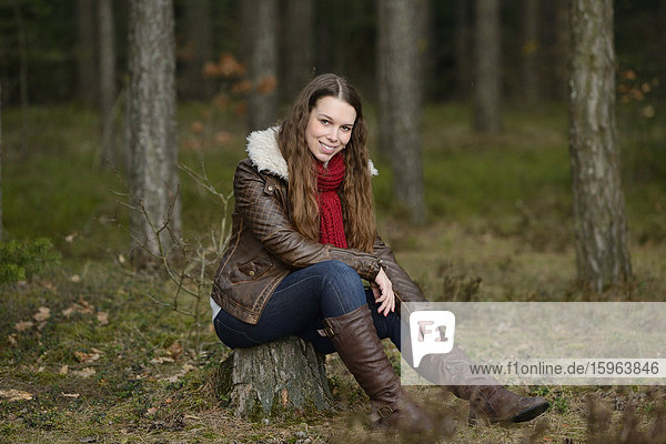 Smiling young woman in forest