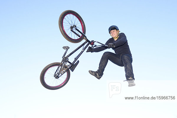 Teenager jumping in the air with his bmx bike