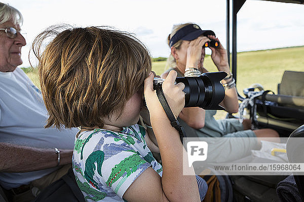 Five year old boy photographing  Moremi Reserve  Botswana