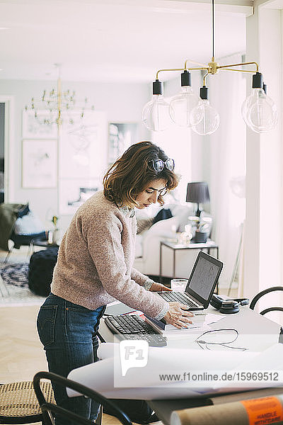 Woman setting up workplace at home