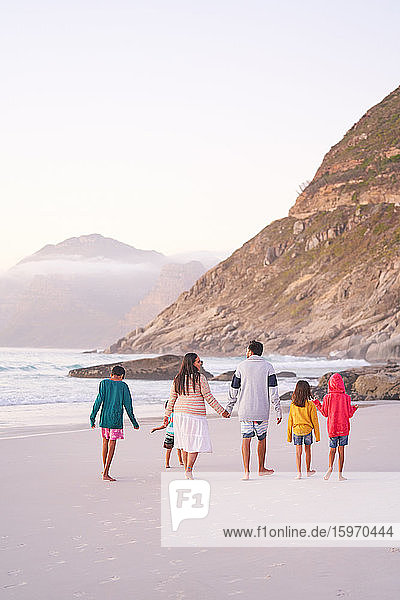 Family walking on ocean beach  Cape Town  South Africa