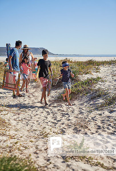 Family walking on sunny beach path  Cape Town  South Africa