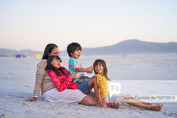Happy family relaxing on beach
