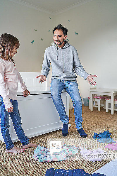 Father helping daughter clean bedroom