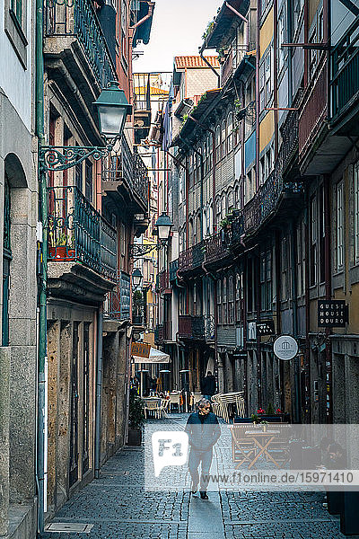 A lone man walking along a back street in Porto  Portugal  Europe