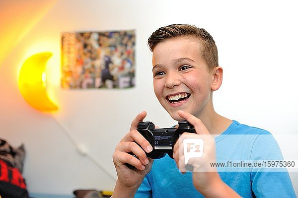 Boy at home playing computer games  Germany  Europe