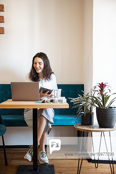 Portrait of smiling young woman working at home office