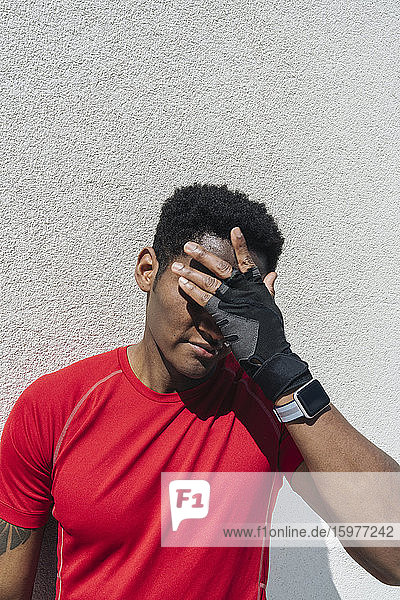 Portrait of sportsman wearing smartwatch and gloves