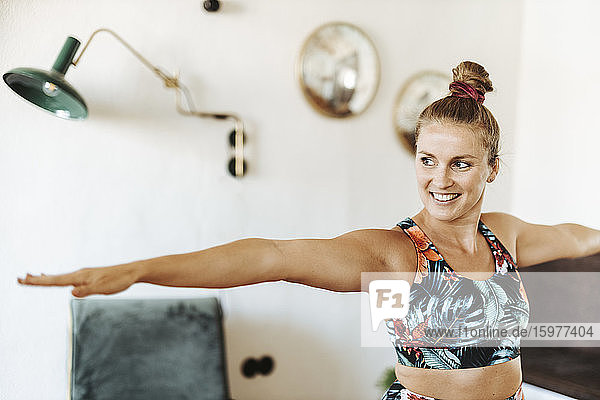 Portrait of woman practicing yoga at home