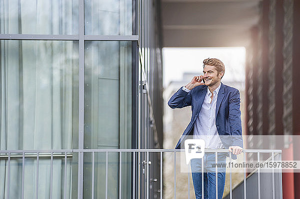 Young businessman on the phone at an office building