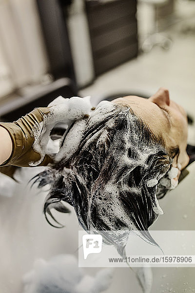 Woman in hair salon getting hair washed