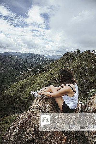 Sri Lanka  Provinz Uva  Ella  Wanderin auf Felsbrocken sitzend am Little Adams Peak