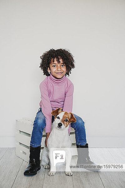 Portrait of smiling little girl and her dog