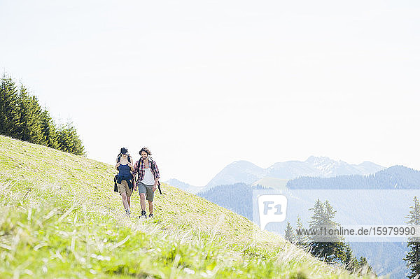 Hiking couple on meadow in summer  Wallberg  Bavaria  Germany