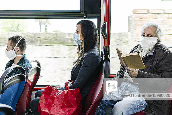 Passengers wearing protective masks in public bus  Spain