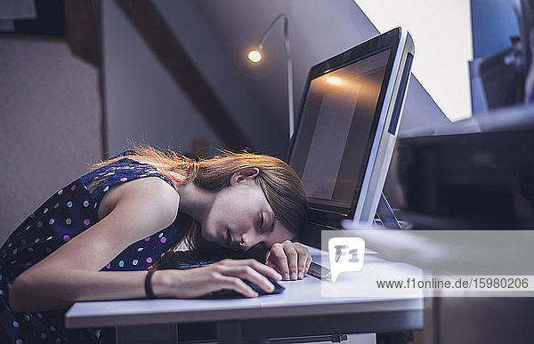Germany  Brandenburg  Teenage girl falling asleep while using computer