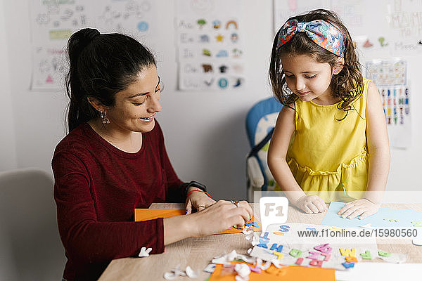 Mother and daughter doing crafts at home