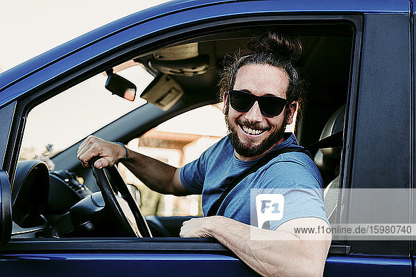 Portrait of happy man in car