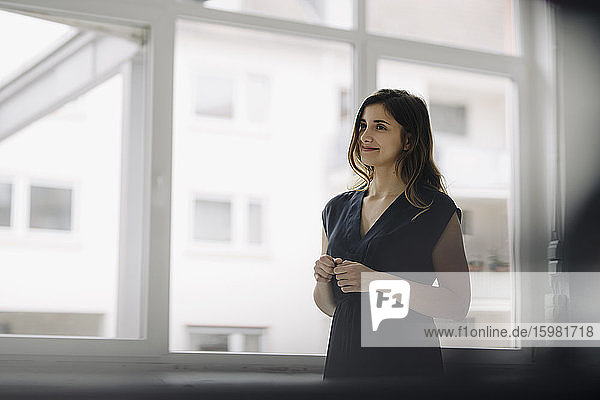 Portrait of smiling young businesswoman in a loft