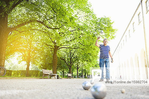 Senior man throwing boules ball