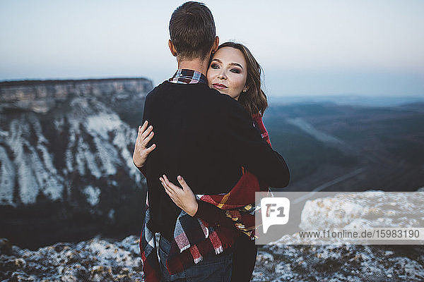 Ukraine  Crimea  Young couple hugging near canyon