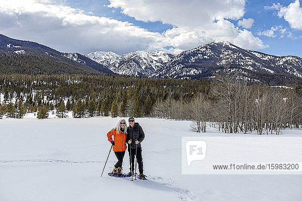 USA  Idaho  Sun Valley  Portrait of man and woman snowshoeing in winter landscape