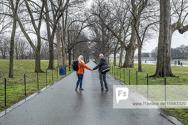 USA  Washington D.C.  Senior couple posing for photo in park