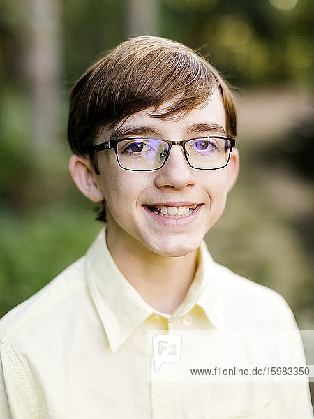 Portrait of smiling teenage boy (14-15) in eyeglasses