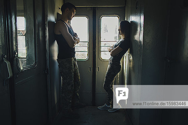 Young couple standing in train
