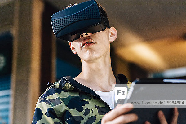 Man looking through virtual reality simulator in city