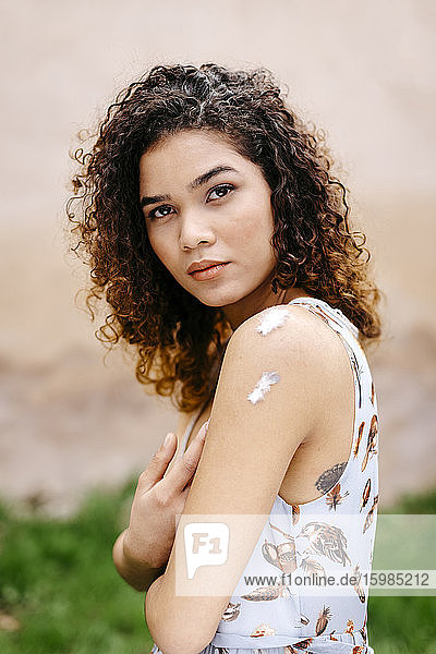 #Portrait of young woman with curly hair outdoors