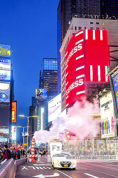 USA  New York  New York City  Rauchschwaden über Autos  die in der Abenddämmerung den Times Square passieren