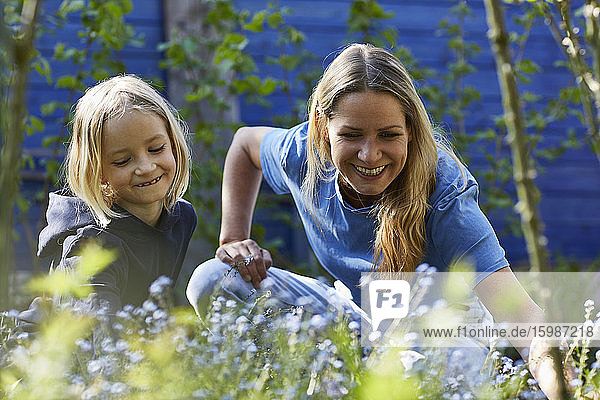 Happy mother and daughter in allotment garden