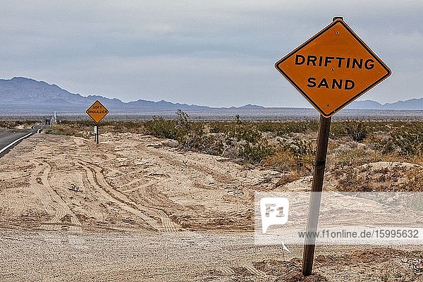Drifting sand road sign in Mojave Desert Rice California USA.