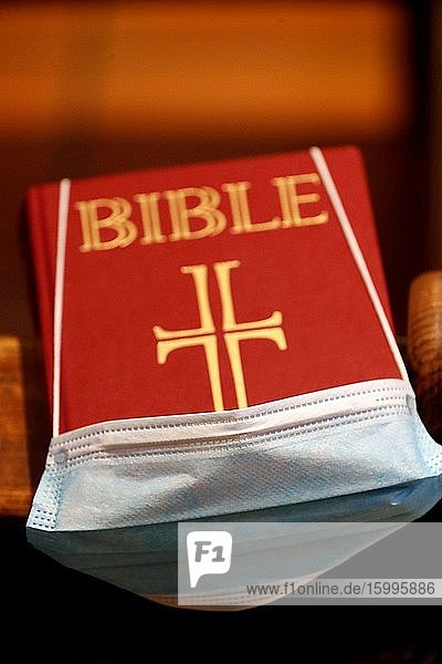 Bible in a church with a disposable mask to avoid contagious coronavirus. France.