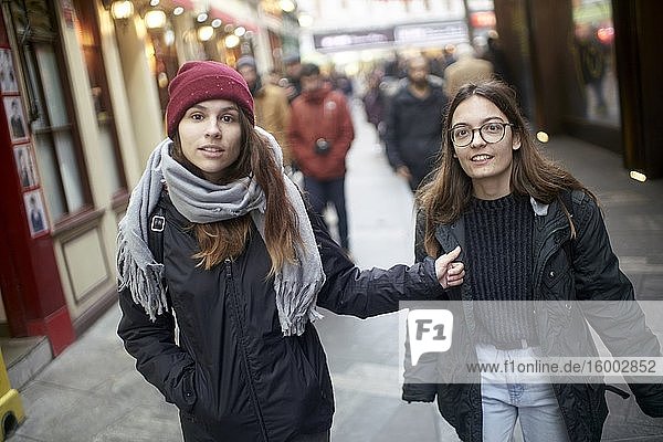 Two women walking at street. London  England.
