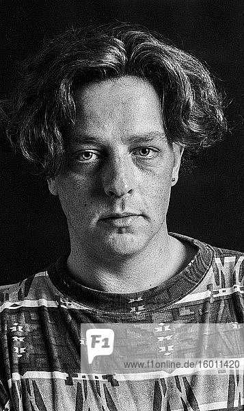 Tilburg  Netherlands. Front view studio portrait of a young adult  caucasian male suffering from a huge depression. Shot on Analog Black & White Film in 1995.