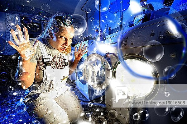 Woman in front of washing machine Corona Series Germany Europe