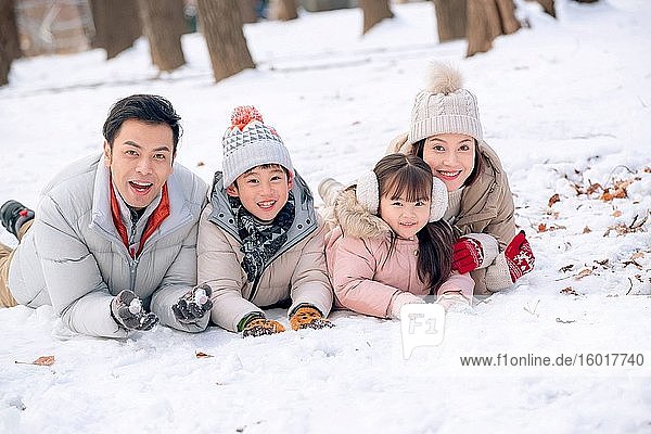 Lying on the snow to play happy family